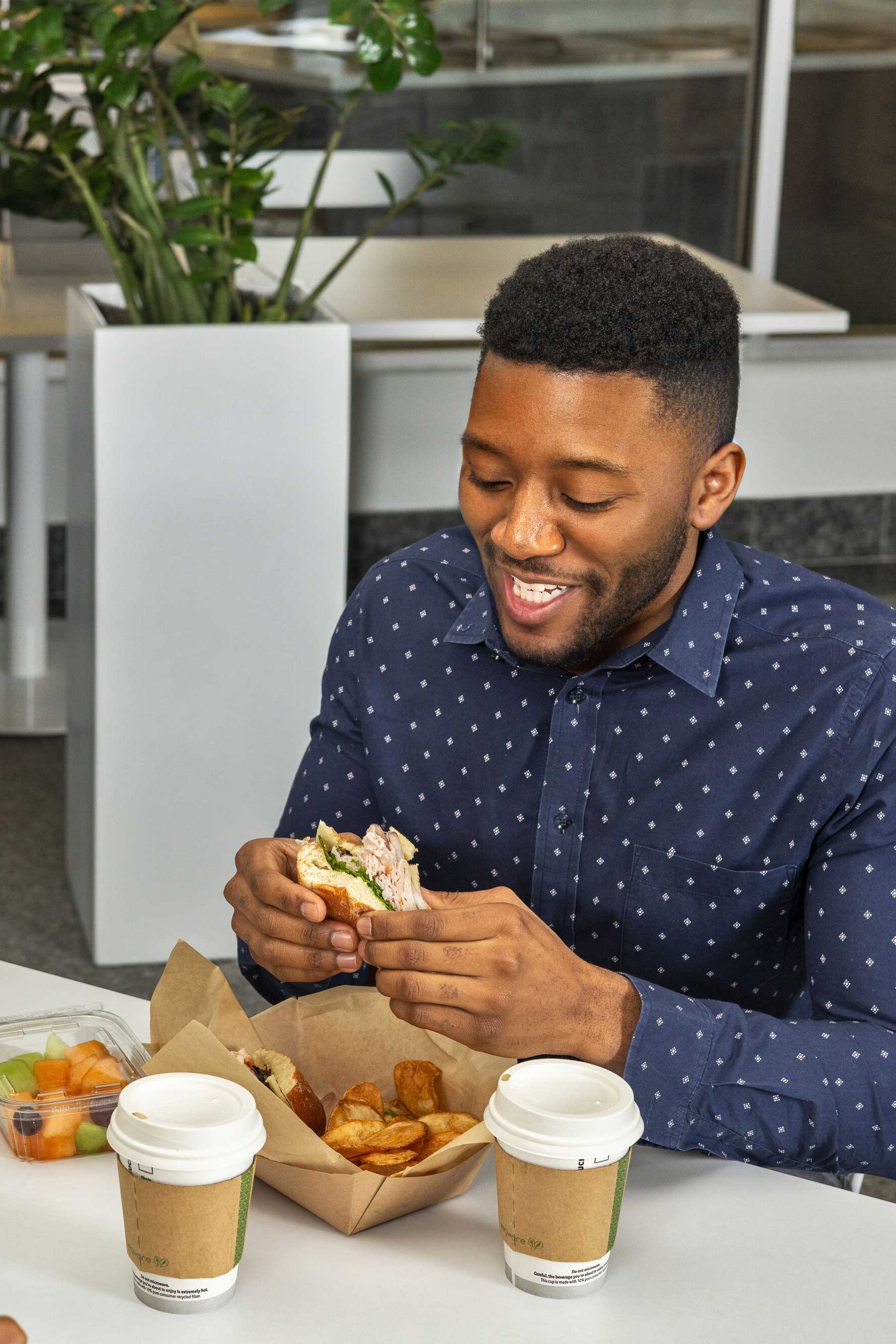 Employee sitting at a table enjoying a meal